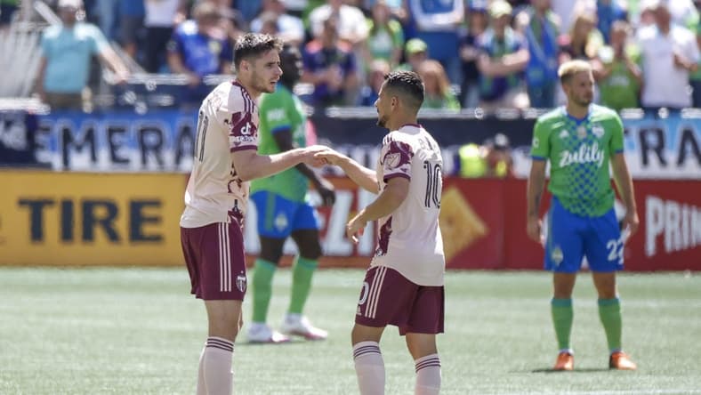 Jul 9, 2022; Seattle, Washington, USA; Portland Timbers forward Jaroslaw Niezgoda (11) shakes hands with midfielder Sebasti n Blanco (10) after scoring a goal against the Seattle Sounders FC during the first half at Lumen Field. Mandatory Credit: Joe Nicholson-USA TODAY Sports