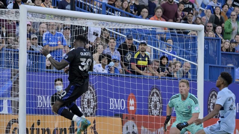 Jul 9, 2022; Montreal, Quebec, CAN; CF Montreal midfielder Romell Quioto (30) scores a goal against Sporting Kansas City goalkeeper Tim Melia (29) during the first half at Stade Saputo. Mandatory Credit: Eric Bolte-USA TODAY Sports