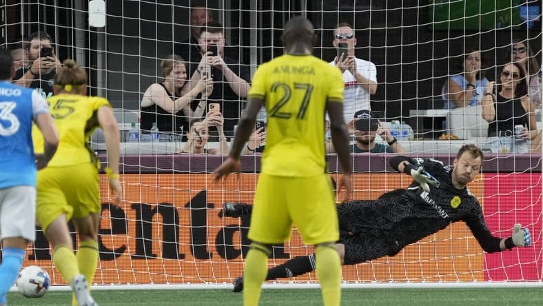 Jul 9, 2022; Charlotte, North Carolina, USA; Nashville SC goalkeeper Joe Willis (1) misses the penalty kick by Charlotte FC defender Christian Fuchs (22) during the first half at Bank of America Stadium. Mandatory Credit: Jim Dedmon-USA TODAY Sports