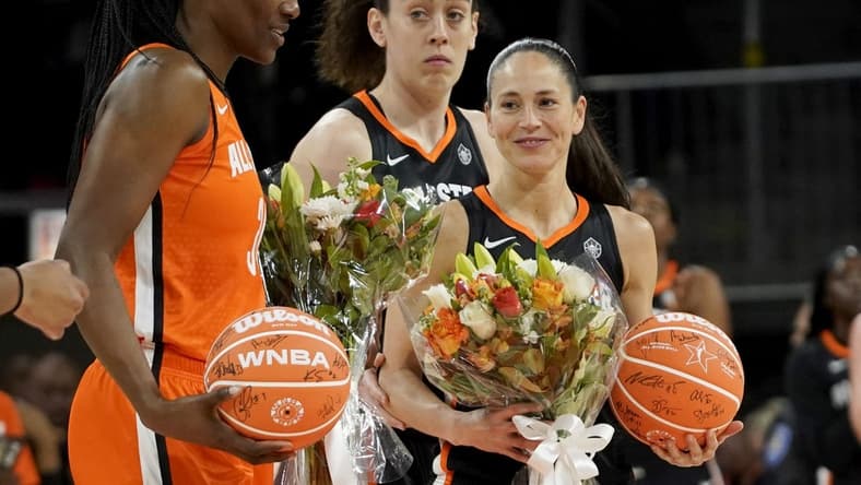 Jul 10, 2022; Chicago, Ill, USA; Team Stewart guard Sue Bird (right) and Team Wilson center Sylvia Fowles (left) are presented with flowers during the first half in a WNBA All Star Game at Wintrust Arena. Mandatory Credit: David Banks-USA TODAY Sports