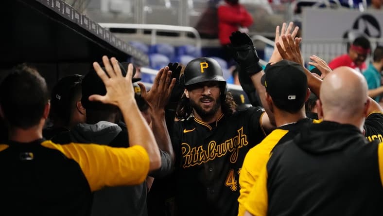Jul 11, 2022; Miami, Florida, USA; Pittsburgh Pirates center fielder Jake Marisnick (41) celebrates with teammates in the dugout after hitting a two-run home run in the ninth inning against the Miami Marlins at loanDepot park. Mandatory Credit: Jasen Vinlove-USA TODAY Sports