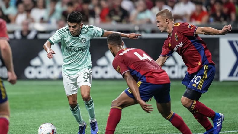 Jul 13, 2022; Atlanta, Georgia, USA; Atlanta United midfielder Thiago Almada (8) controls the ball past Real Salt Lake defender Johan Kappelhof (4) during the first half at Mercedes-Benz Stadium. Mandatory Credit: Dale Zanine-USA TODAY Sports