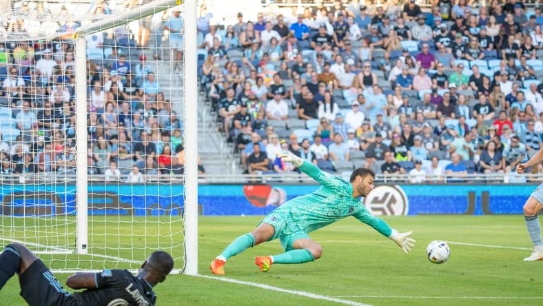 Jul 13, 2022; Saint Paul, Minnesota, USA; Minnesota United defender Kemar Lawrence (92) looks on as Sporting Kansas City goalkeeper John Pulskamp (1) defends an own goal in the first half at Allianz Field. Mandatory Credit: Matt Blewett-USA TODAY Sports