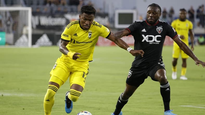 Jul 13, 2022; Washington, District of Columbia, USA; Columbus Crew midfielder Luis D az (12) dribbles the ball as D.C. United defender Chris Odoi-Atsem (3) defends in the first half at Audi Field. Mandatory Credit: Geoff Burke-USA TODAY Sports