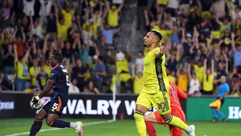 Jul 13, 2022; Nashville, Tennessee, USA; Nashville SC midfielder Hany Mukhtar (10) celebrates after a goal during the first half against the Seattle Sounders at GEODIS Park. Mandatory Credit: Christopher Hanewinckel-USA TODAY Sports