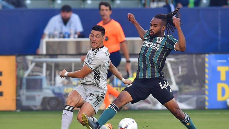 Jul 13, 2022; Carson, California, USA; Los Angeles Galaxy forward Raheem Edwards (44) plays for the ball against San Jose Earthquakes forward Cristian Espinoza (10) during the first half at Dignity Health Sports Park. Mandatory Credit: Gary A. Vasquez-USA TODAY Sports