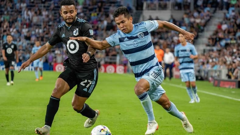 Jul 13, 2022; Saint Paul, Minnesota, USA; Sporting Kansas City midfielder Felipe Hernandez (21) is challenged by Minnesota United defender D.J. Taylor (27) in the second half at Allianz Field. Mandatory Credit: Matt Blewett-USA TODAY Sports