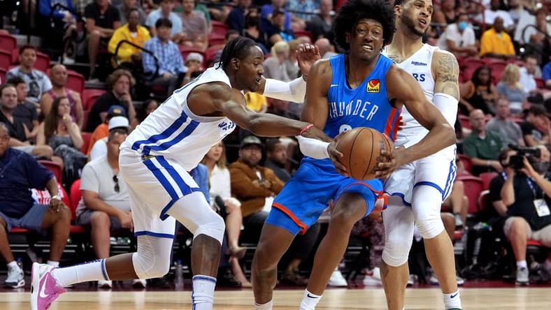 Jul 15, 2022; Las Vegas, NV, USA; Oklahoma City Thunder forward Jaylin Williams (6) drives between Golden State Warriors forward Jonathan Kuminga (0) and Golden State Warriors guard Quinndary Weatherspoon (12) during an NBA Summer League game at Thomas & Mack Center. Mandatory Credit: Stephen R. Sylvanie-USA TODAY Sports