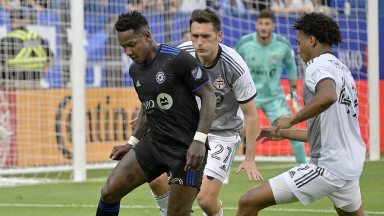 Jul 16, 2022; Montreal, Quebec, CAN; CF Montreal midfielder Romell Quioto (30) controls the ball against Toronto FC defender Shane O'Neill (27) and midfielder Kosi Thompson (47) during the first half at Stade Saputo. Mandatory Credit: Eric Bolte-USA TODAY Sports