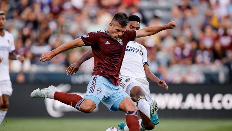Jul 16, 2022; Commerce City, Colorado, USA; Colorado Rapids midfielder Diego Rubio (11) scores on a shot as LA Galaxy midfielder Rayan Raveloson (6) defends in the first half at Dick's Sporting Goods Park. Mandatory Credit: Isaiah J. Downing-USA TODAY Sports