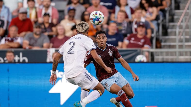 Jul 16, 2022; Commerce City, Colorado, USA; Colorado Rapids midfielder Jonathan Lewis (7) fields the ball ahead of LA Galaxy defender Julian Araujo (2) in the first half at Dick's Sporting Goods Park. Mandatory Credit: Isaiah J. Downing-USA TODAY Sports