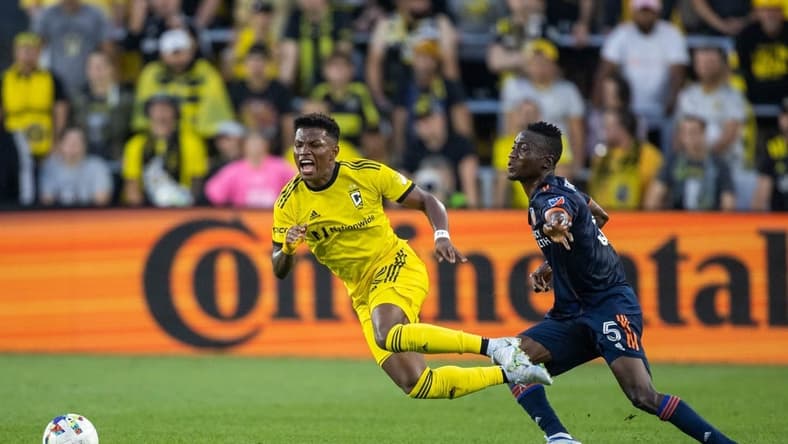 Jul 17, 2022; Columbus, Ohio, USA; Columbus Crew midfielder Luis Diaz (12) is fouled by FC Cincinnati midfielder Obinna Nwobodo (5) in the first half at Lower.com Field. Mandatory Credit: Trevor Ruszkowski-USA TODAY Sports