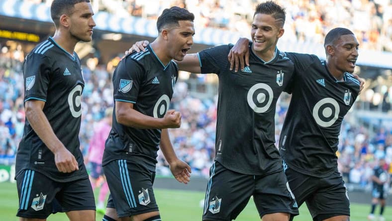 Jul 20, 2022; Minneapolis, MN, USA; Minnesota United midfielder Emanuel Reynoso (10) celebrates his penalty kick goal against Everton with midfielder Franco Fragapane (7), forward Luis Amarilla (9) and midfielder Joseph Rosales (8) in the first half at Allianz Field. Mandatory Credit: Matt Blewett-USA TODAY Sports
