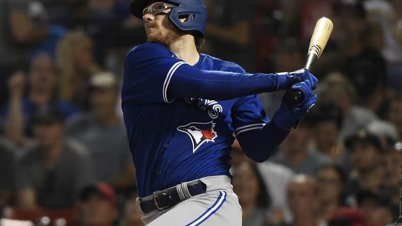 Jul 22, 2022; Boston, Massachusetts, USA; Toronto Blue Jays catcher Danny Jansen (9) hits a home run during the fourth inning against the Boston Red Sox at Fenway Park. Mandatory Credit: Bob DeChiara-USA TODAY Sports