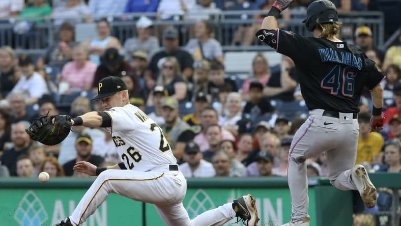 Jul 23, 2022; Pittsburgh, Pennsylvania, USA; Pittsburgh Pirates first baseman Josh VanMeter (26) drops a throw at first base allowing Miami Marlins left fielder Luke Williams (46) to safely reach base on an error during the third inning at PNC Park. Mandatory Credit: Charles LeClaire-USA TODAY Sports