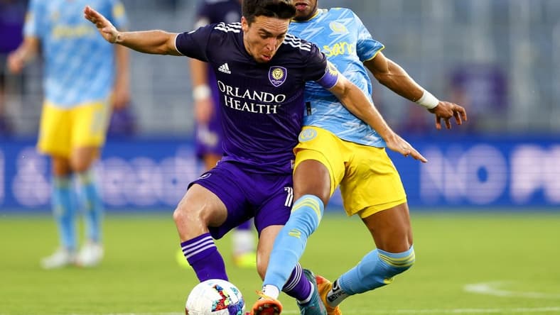 Jul 23, 2022; Orlando, Florida, USA; Orlando City midfielder Mauricio Pereyra (10) and Philadelphia Union midfielder Jose Andres Martinez (8) battle for possession in the first half at Exploria Stadium. Mandatory Credit: Nathan Ray Seebeck-USA TODAY Sports