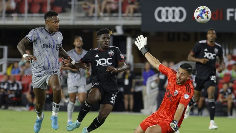 Jul 23, 2022; Washington, District of Columbia, USA; CF Montr al forward Romell Quioto (30) scores a goal on D.C. United goalkeeper Rafael Romo (1) as D.C. United defender Gaoussou Samak (2) defends in the first half at Audi Field. Mandatory Credit: Geoff Burke-USA TODAY Sports