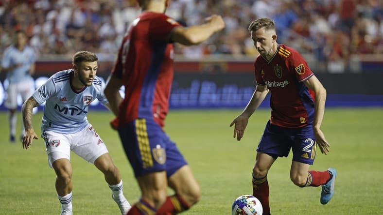 Jul 23, 2022; Sandy, Utah, USA; Real Salt Lake defender Andrew Brody (2) looks to pass to forward Justin Meram (9) against FC Dallas forward Paul Arriola (7) in the second half at Rio Tinto Stadium. Mandatory Credit: Jeffrey Swinger-USA TODAY Sports