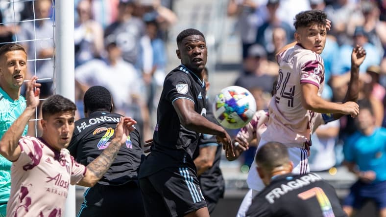 Jul 30, 2022; Saint Paul, Minnesota, USA; Portland Timbers midfielder David Ayala (24) and Minnesota United defender Bakaye Dibassy (12) watch as midfielder Franco Fragapane (7) heads the corner kick for a goal in the first half at Allianz Field. Mandatory Credit: Matt Blewett-USA TODAY Sports