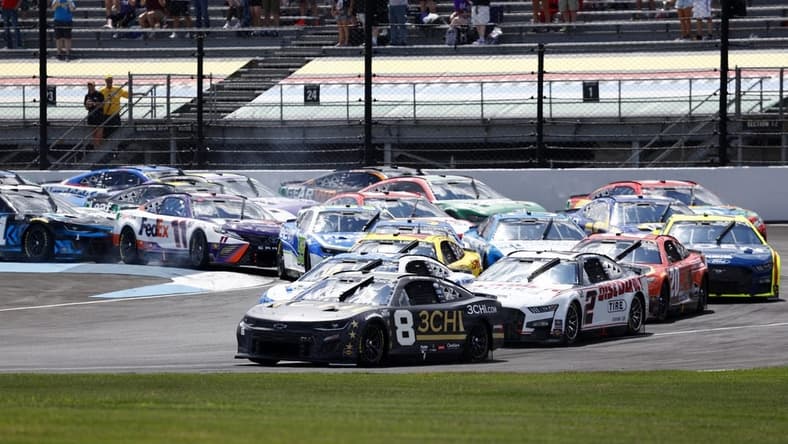 Jul 31, 2022; Speedway, Indiana, USA; NASCAR Cup Series driver Tyler Reddick (8) leads the field during the Verizon 200 at Indianapolis Motor Speedway Road Course. Mandatory Credit: Mike Dinovo-USA TODAY Sports