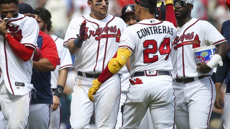 Jul 31, 2022; Atlanta, Georgia, USA; Atlanta Braves third baseman Austin Riley (27) celebrates with catcher William Contreras (24) after a game-winning RBI double against the Arizona Diamondbacks at Truist Park. Mandatory Credit: Brett Davis-USA TODAY Sports