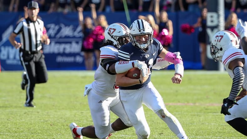 Oct 27, 2018; Provo, UT, USA; Brigham Young Cougars quarterback Zach Wilson (11) is tackled from behind by Northern Illinois Huskies linebacker Kyle Pugh (57) during the second half at LaVell Edwards Stadium. Northern Illinois Huskies won 7-6. Mandatory Credit: Chris Nicoll-USA TODAY Sports