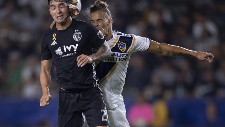 Sep 15, 2019; Carson, CA, USA; Sporting Kansas City midfielder Felipe Gutierrez (21) and LA Galaxy forward Ethan Zubak (29) battle for the ball during the first half at StubHub Center. Mandatory Credit: Kelvin Kuo-USA TODAY Sports