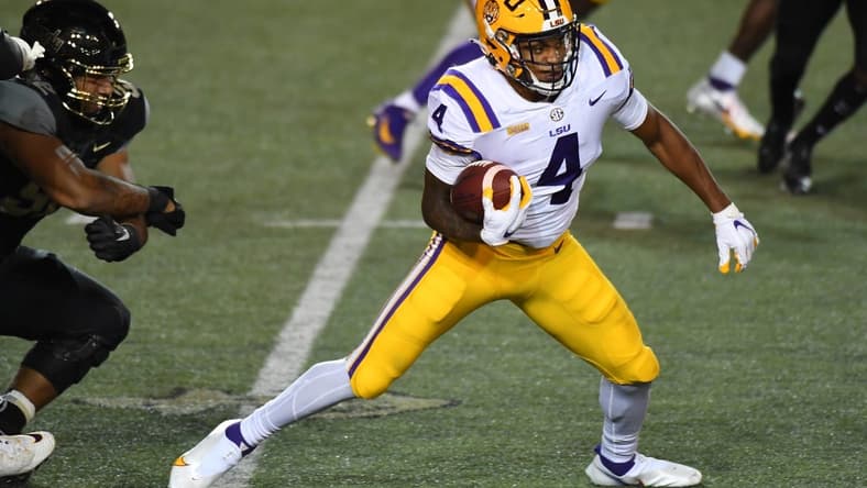 Oct 3, 2020; Nashville, Tennessee, USA; LSU Tigers running back John Emery Jr. (4) runs for a first down during the first half against the Vanderbilt Commodores at Vanderbilt Stadium. Mandatory Credit: Christopher Hanewinckel-USA TODAY Sports