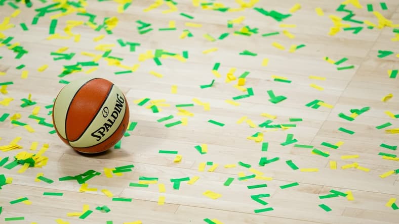 Oct 6, 2020; Bradenton, Florida, USA; A game ball rests on the court amidst green and yellow confetti after the Seattle Storm win the 2020 WNBA Finals at IMG Academy. Mandatory Credit: Mary Holt-USA TODAY Sports