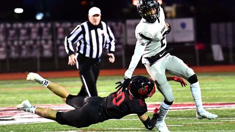 Lakota East's Caleb VanHooser (2) is tripped up by Silas Walters (10) of Lakota West in second-round OHSAA Division I playoff action, Oct. 16. 2020.

Ew 115