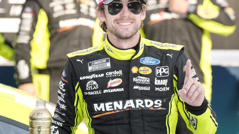 Aug 22, 2021; Brooklyn, Michigan, USA; NASCAR Cup Series driver Ryan Blaney (12) poses with the trophy after winning the FireKeepers Casino 400 at Michigan International Speedway. Mandatory Credit: Mike Dinovo-USA TODAY Sports