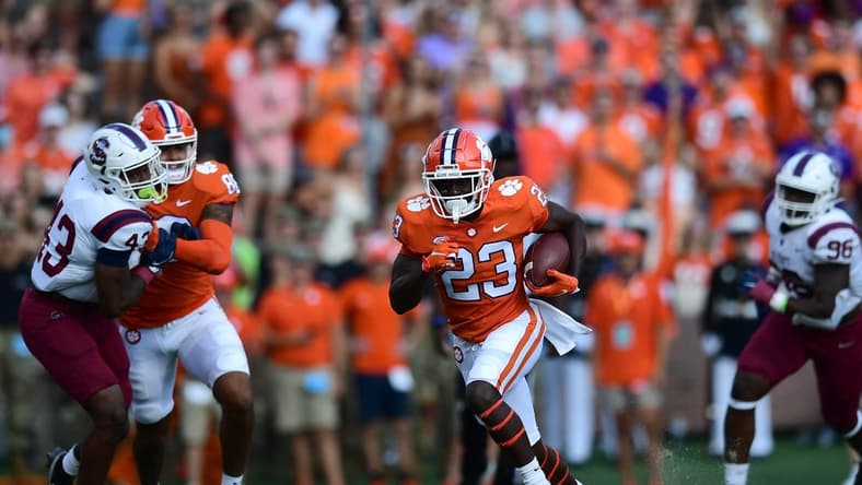 Sep 11, 2021; Clemson, South Carolina, USA; Clemson Tigers running back Lyn-J Dixon (23) carries the ball against the South Carolina State Bulldogs during the first quarter at Memorial Stadium. Mandatory Credit: Adam Hagy-USA TODAY Sports