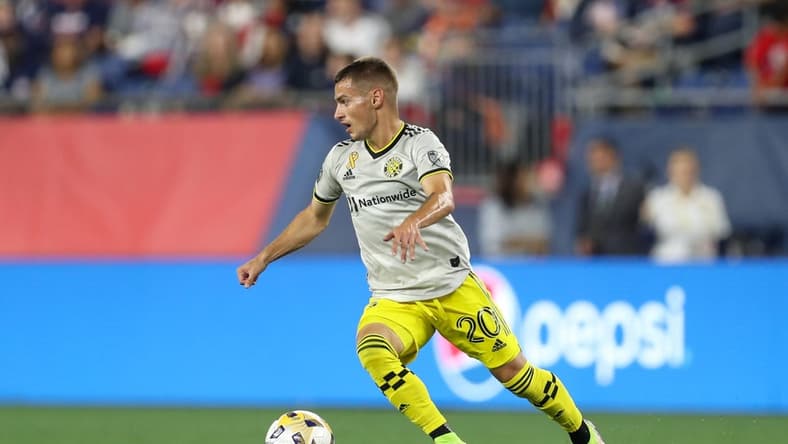 Sep 18, 2021; Foxborough, Massachusetts, USA; Columbus Crew midfielder Alexandru Matan (20) possesses the ball against the New England Revolution at Gillette Stadium. Mandatory Credit: Paul Rutherford-USA TODAY Sports