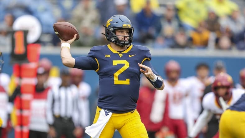 Oct 30, 2021; Morgantown, West Virginia, USA; West Virginia Mountaineers quarterback Jarret Doege (2) throws a pass during the first quarter against the Iowa State Cyclones at Mountaineer Field at Milan Puskar Stadium. Mandatory Credit: Ben Queen-USA TODAY Sports