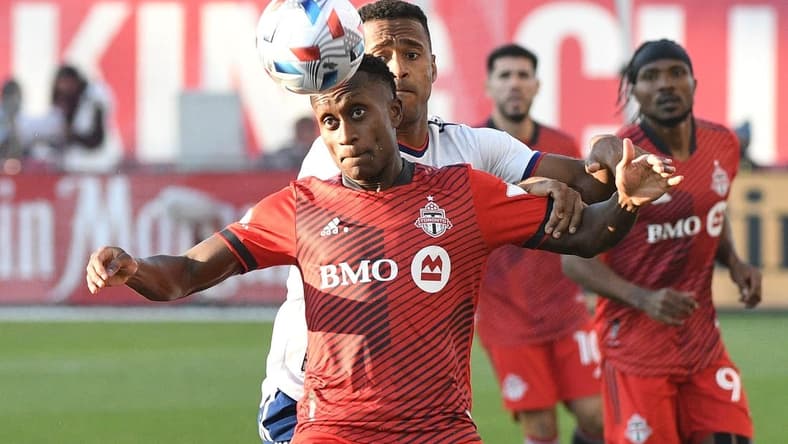 Nov 7, 2021; Toronto, Ontario, CAN;  Toronto FC defender Richie Laryea (22) watches the ball ahead of DC United forward Ola Kamara (9) in the first half at BMO Field. Mandatory Credit: Dan Hamilton-USA TODAY Sports