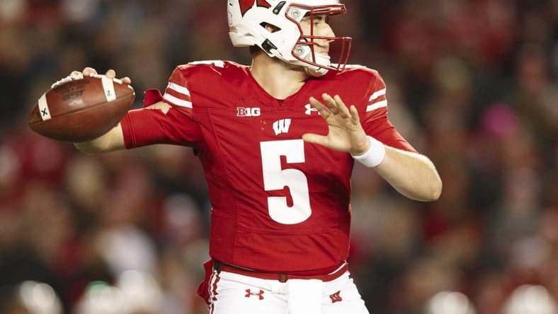 Nov 20, 2021; Madison, Wisconsin, USA;  Wisconsin Badgers quarterback Graham Mertz (5) throws a pass during the third quarter against the Nebraska Cornhuskers at Camp Randall Stadium. Mandatory Credit: Jeff Hanisch-USA TODAY Sports