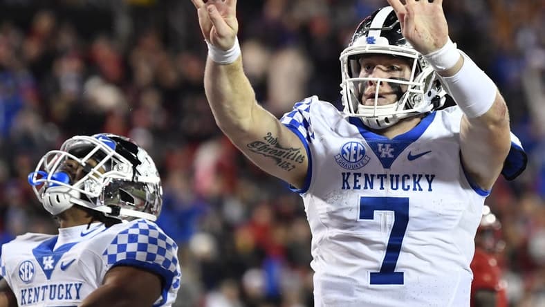 Nov 27, 2021; Louisville, Kentucky, USA;  Kentucky Wildcats quarterback Will Levis (7) celebrates after scoring his fourth touchdown against the Louisville Cardinals during the second half at Cardinal Stadium. Kentucky won 52-21. Mandatory Credit: Jamie Rhodes-USA TODAY Sports