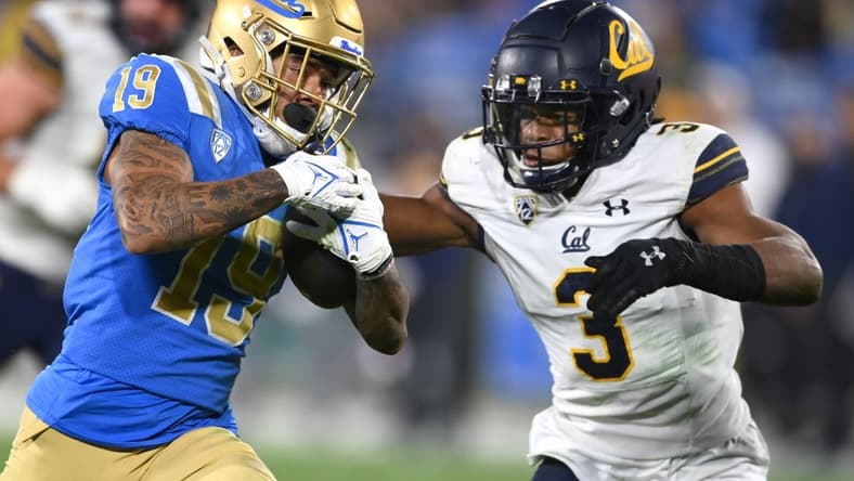 Nov 27, 2021; Pasadena, California, USA;   UCLA Bruins running back Kazmeir Allen (19) is stopped by California Golden Bears safety Elijah Hicks (3) just short of the goal line after a pass reception in the second half at the Rose Bowl. Mandatory Credit: Jayne Kamin-Oncea-USA TODAY Sports
