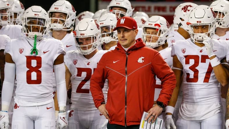 Nov 26, 2021; Seattle, Washington, USA; Washington State Cougars head coach Jake Dickert stands outside the locker room with wide receiver Calvin Jackson Jr. (8), running back Max Borghi (21) and linebacker Justus Rogers (37) before kickoff against the Washington Huskies at Alaska Airlines Field at Husky Stadium. Mandatory Credit: Joe Nicholson-USA TODAY Sports