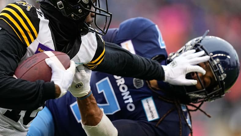 Dec 5, 2021; Toronto, Ontario, CAN; Hamilton Tiger-Cats wide receiver Brandon Banks (16) and Toronto Argonauts defensive back Jalen Collins (7) after a pass reception during the Canadian Football League Eastern Conference Final game at BMO Field. Mandatory Credit: John E. Sokolowski-USA TODAY Sports