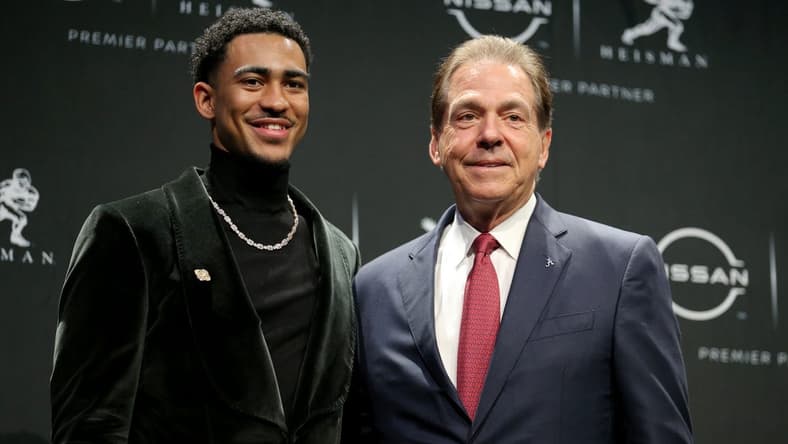 Dec 11, 2021; New York, NY, USA; 2021 Heisman winner Alabama quarterback Bryce Young (left) poses for pictures with head coach Nick Saban during a press conference at the New York Marriott Marquis in New York City. Mandatory Credit: Brad Penner-USA TODAY Sports