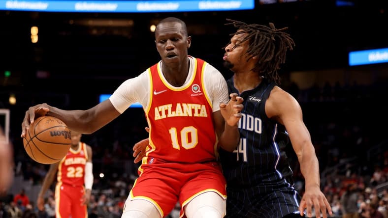 Dec 22, 2021; Atlanta, Georgia, USA; Atlanta Hawks center Gorgui Dieng (10) makes a move on Orlando Magic forward Freddie Gillespie (44) during the second quarter at State Farm Arena. Mandatory Credit: Jason Getz-USA TODAY Sports