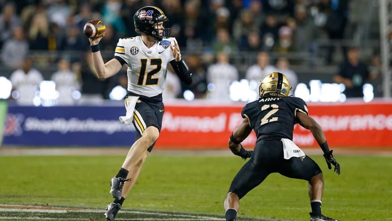 Dec 22, 2021; Fort Worth, Texas, USA; Missouri Tigers quarterback Brady Cook (12) throws with Army Black Knights linebacker Malkelm Morrison (2) defending during the third quarter of the 2021 Armed Forces Bowl at Amon G. Carter Stadium. Mandatory Credit: Andrew Dieb-USA TODAY Sports