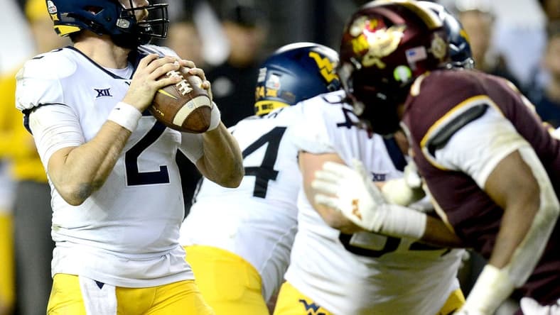 Dec 28, 2021; Phoenix, AZ, USA; West Virginia Mountaineers quarterback Jarret Doege (2) drops back to pass against the Minnesota Golden Gophers during the second half at Chase Field. Mandatory Credit: Joe Camporeale-USA TODAY Sports