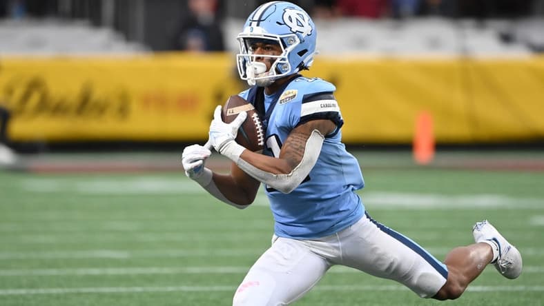 Dec 30, 2021; Charlotte, NC, USA; North Carolina Tar Heels wide receiver Josh Downs (11) catches the ball in the second quarter during the 2021 Duke's Mayo Bowl at Bank of America Stadium. Mandatory Credit: Bob Donnan-USA TODAY Sports