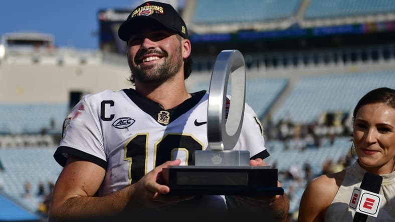 Wake Forest Demon Deacons quarterback Sam Hartman (10) holds up the MVP trophy after the game Friday, Dec. 31, 2021 at TIAA Bank Field in Jacksonville. The Wake Forest Demon Deacons and the Rutgers Scarlet Knights faced each other in the 2021 TaxSlayer Gator Bowl. Wake Forest defeated Rutgers 38-10. [Corey Perrine/Florida Times-Union]