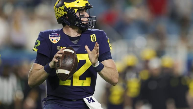 Dec 31, 2021; Miami Gardens, Florida, USA; Michigan Wolverines quarterback Cade McNamara (12) looks to throw against the Georgia Bulldogs in the third quarter during the Orange Bowl college football CFP national semifinal game at Hard Rock Stadium. Mandatory Credit: Sam Navarro-USA TODAY Sports