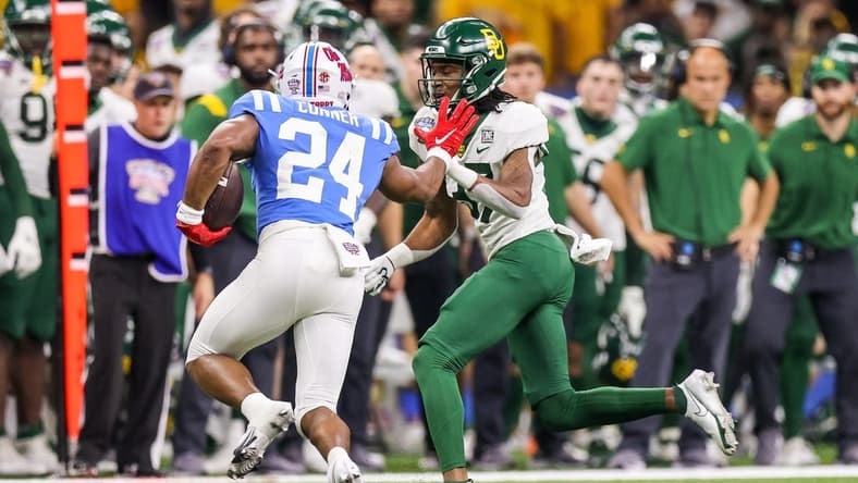 Jan 1, 2022; New Orleans, LA, USA;  Mississippi Rebels running back Snoop Conner (24) rushes against the Baylor Bears cornerback Mark Milton (37) during the second half of the 2022 Sugar Bowl at the Caesars Superdome. Mandatory Credit: Stephen Lew-USA TODAY Sports
