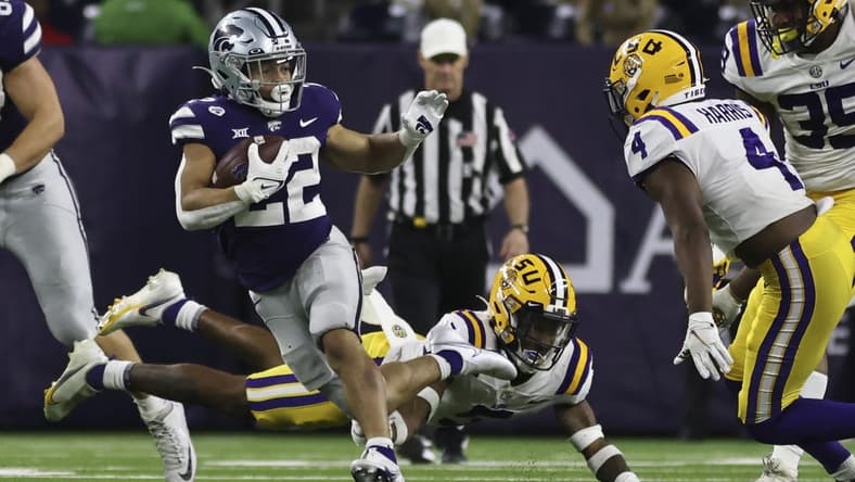 Jan 4, 2022; Houston, TX, USA; Kansas State Wildcats running back Deuce Vaughn (22) rushes against LSU Tigers safety Todd Harris Jr. (4) in the fourth quarter in the 2022 Texas Bowl at NRG Stadium. Mandatory Credit: Thomas Shea-USA TODAY Sports