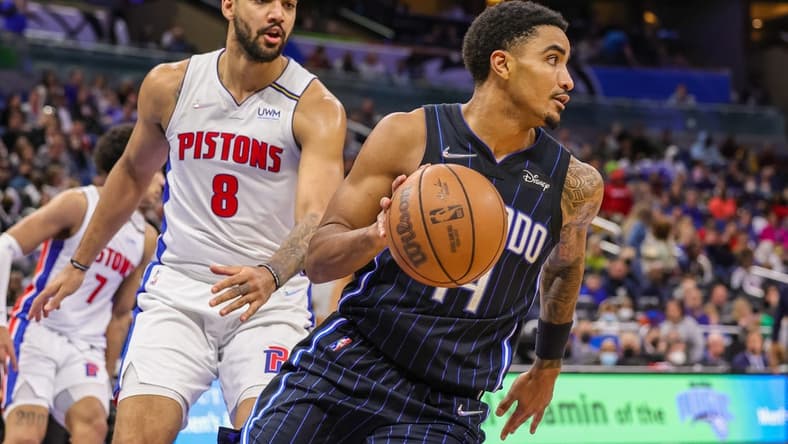 Jan 28, 2022; Orlando, Florida, USA; Orlando Magic guard Gary Harris (14) moves the ball past Detroit Pistons forward Trey Lyles (8) during the second half at Amway Center. Mandatory Credit: Mike Watters-USA TODAY Sports
